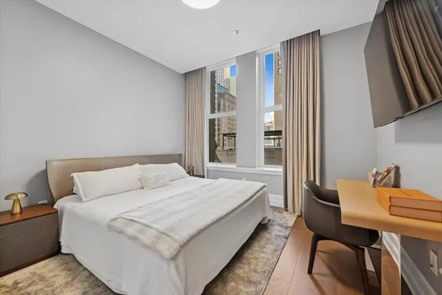 a living room with a bed furniture and a window