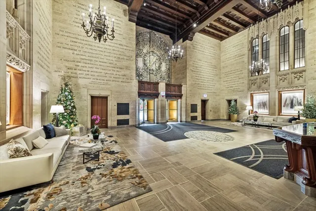 a living room with fireplace furniture and a chandelier