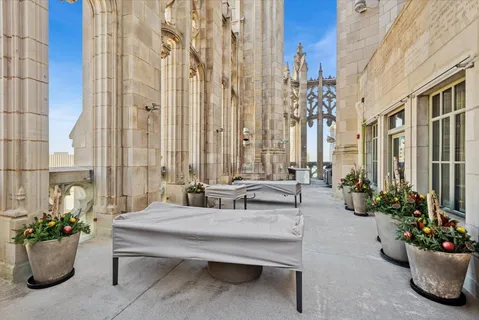 a living room with patio furniture and flowers