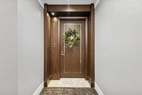 a view of a hallway with wooden floor and a hallway