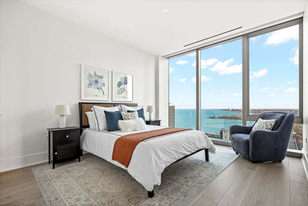 363 East Wacker Drive, Unit 4103 Chicago, IL 60601 - Photo 13 of 34 a bedroom with a bed and a large window