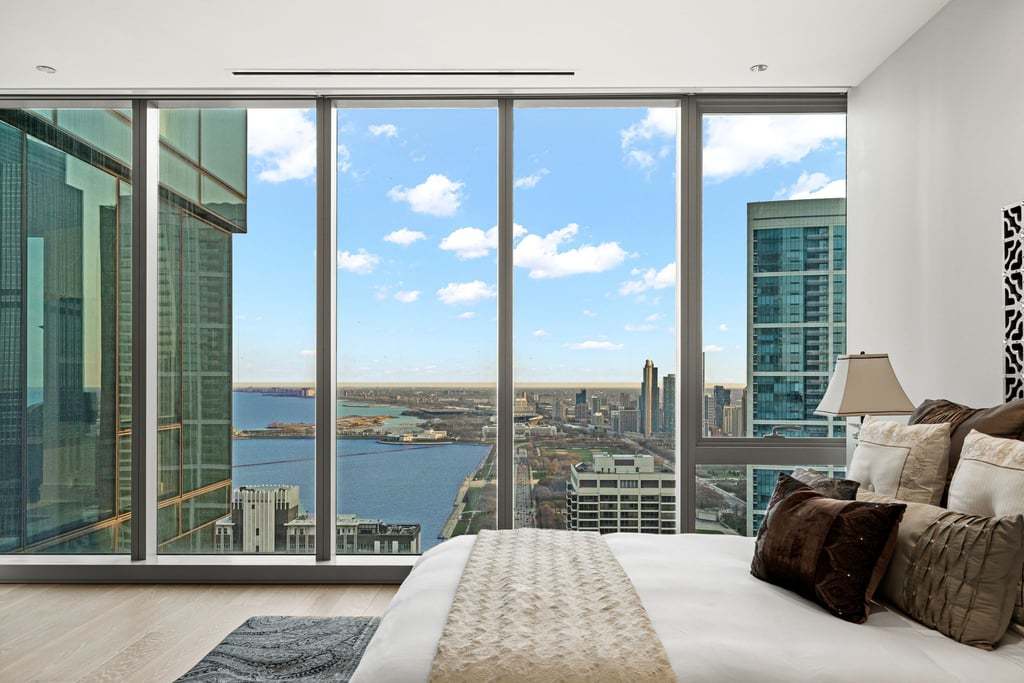 363 East Wacker Drive, Unit 4103 Chicago, IL 60601 - Photo 9 of 34 a bedroom with a large window and a balcony