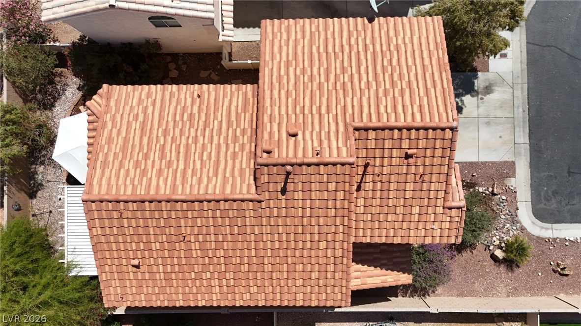 8934 Deep Ridge Court Las Vegas, NV 89178 - Photo 32 of 47 An aerial perspective reveals the robust tile roof and surrounding xeriscaped landscape.
