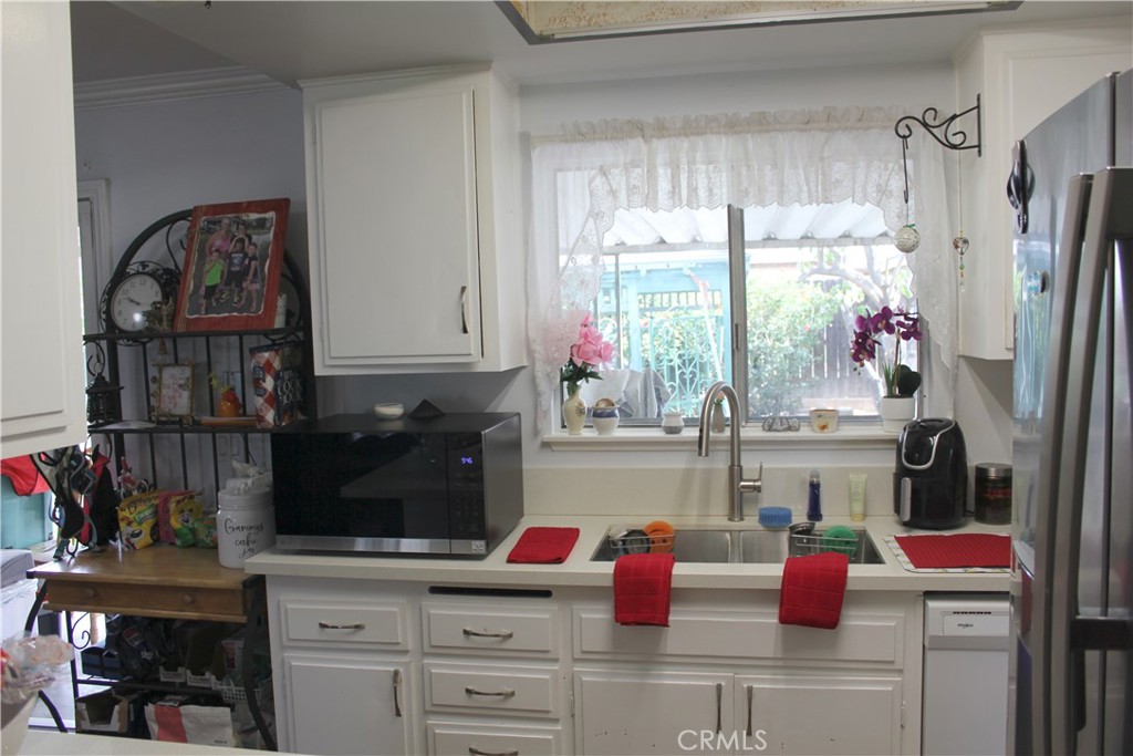 5911 Green Valley Road Riverside, CA 92504 - Photo 4 of 24 a kitchen with a window and cabinets