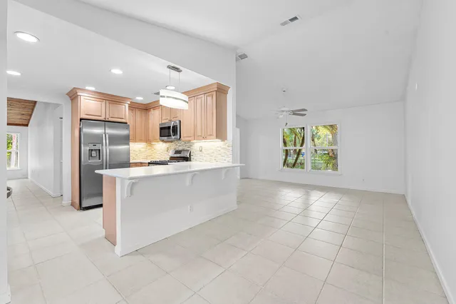 a kitchen with white cabinets and a sink