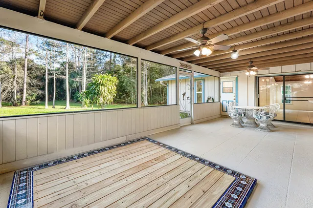 a very nice looking room with wooden floor and furniture
