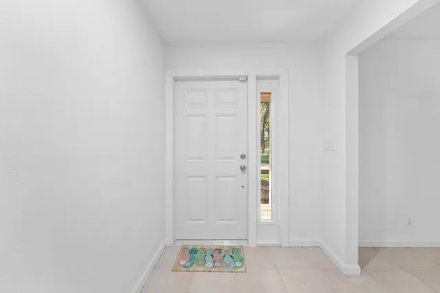 an empty room with a ceiling fan and a window