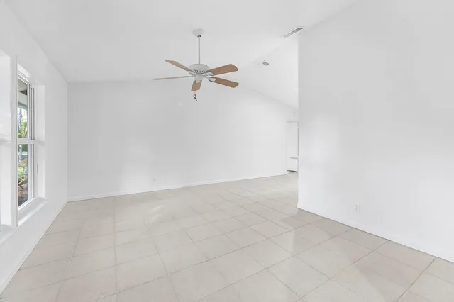 a large white kitchen with a sink and cabinets