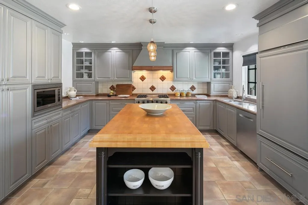 6117 La Flecha Rancho Santa Fe, CA 92067 - Photo 5 of 37 a kitchen with stainless steel appliances granite countertop a stove a sink and a refrigerator