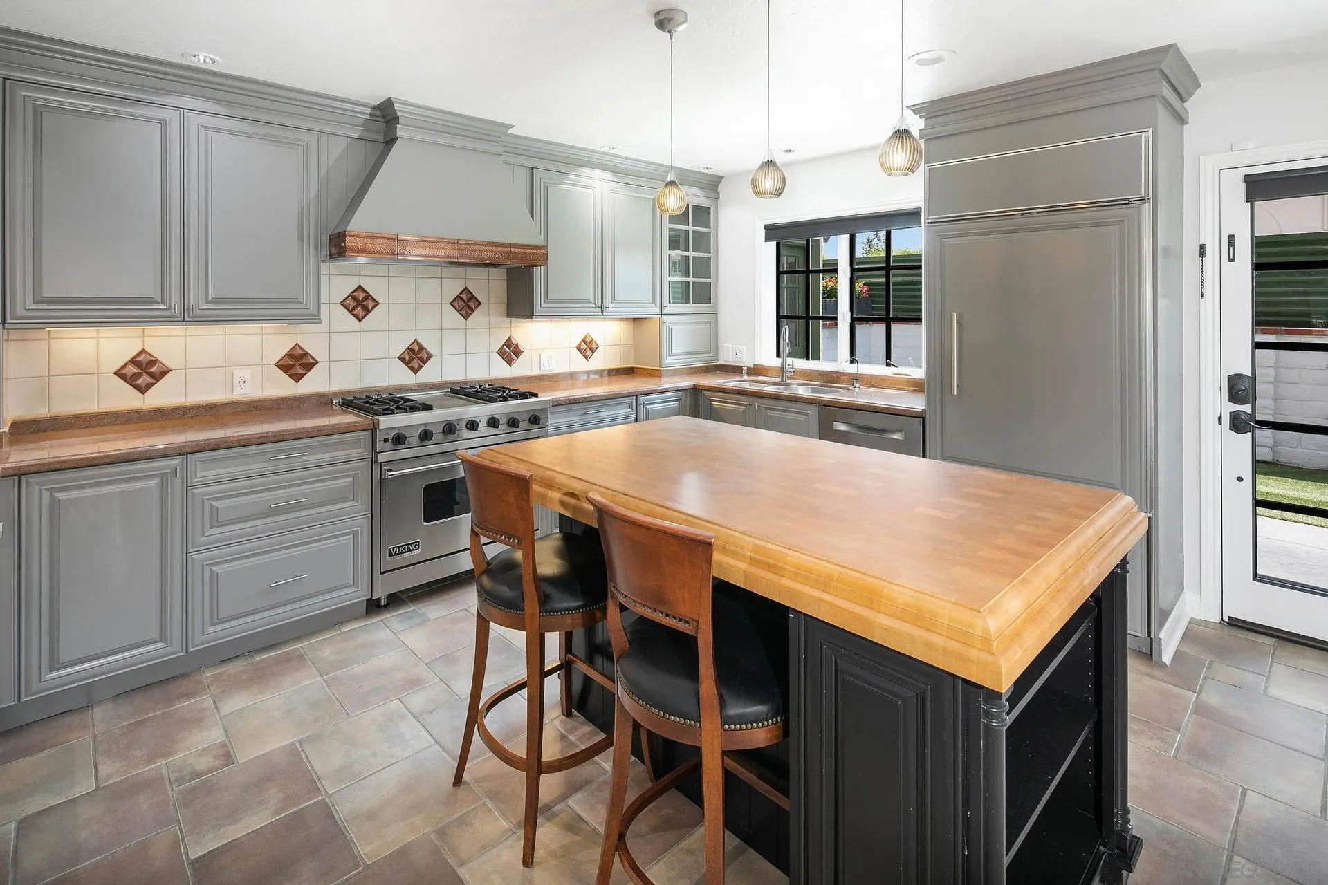6117 La Flecha Rancho Santa Fe, CA 92067 - Photo 6 of 37 a kitchen with a stove a sink a dining table and chairs