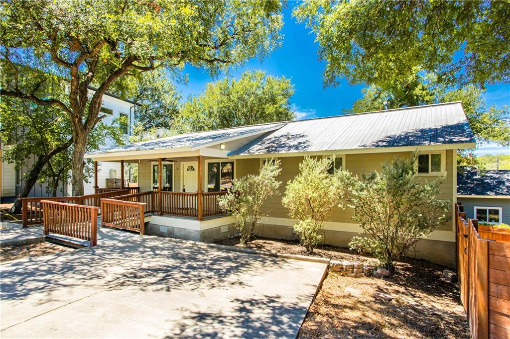 View of front of home featuring crawl space, a metal roof, and a porch