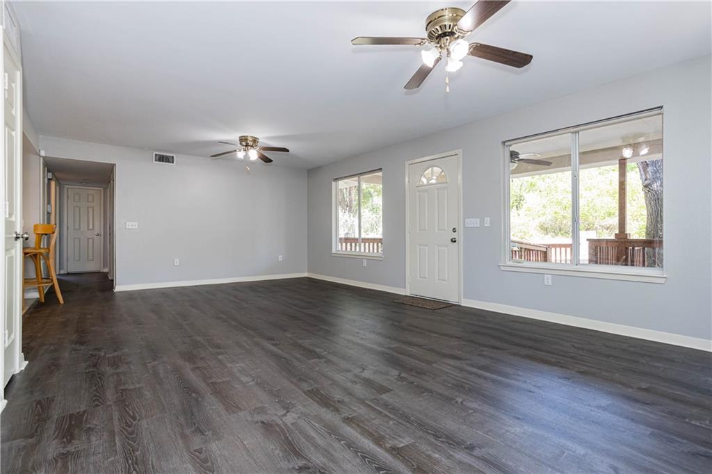 1326 Delano Street Austin, TX 78721 - Photo 9 of 23 Unfurnished living room featuring dark wood-style flooring and ceiling fan