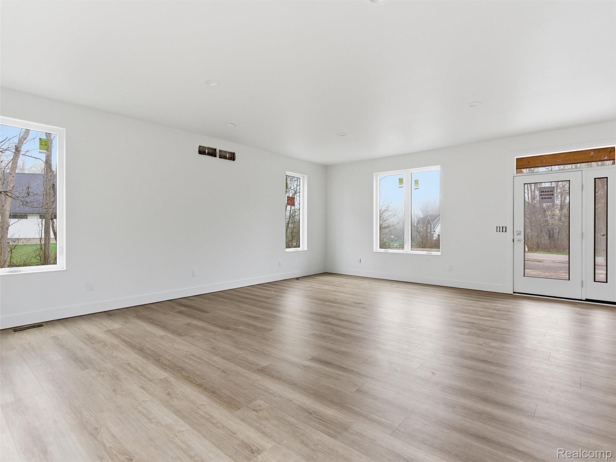 11810 Scenic Valley Road Davisburg, MI 48350 - Photo 5 of 46 Empty room featuring baseboards and light wood-style flooring