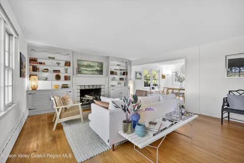 a bedroom with furniture and a large window