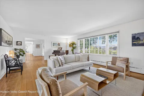 a view of swimming pool with lawn chairs and plants