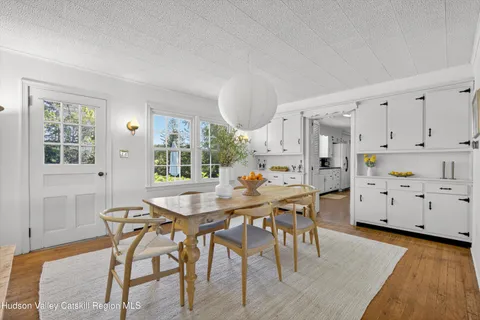 a front view of a house with swimming pool and yard