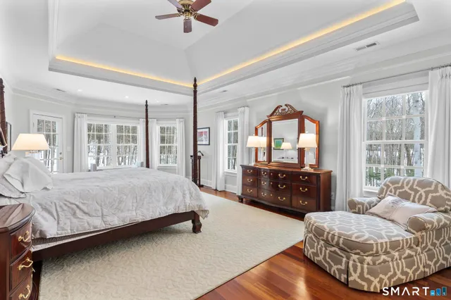 a bedroom with a large bed and a chandelier