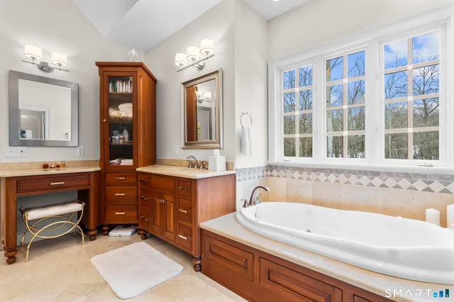 a spacious bathroom with a double vanity sink and a mirror