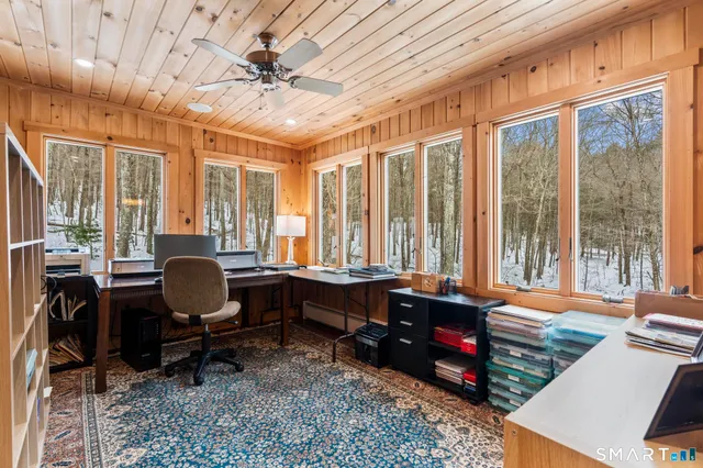 a room with furniture a rug and wooden floor