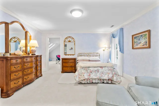 a spacious bedroom with a bed and a couch