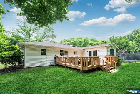 a view of a house with a yard and deck