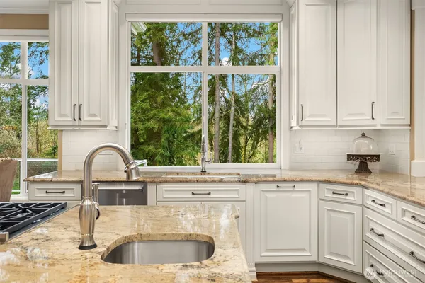 a kitchen with granite countertop a sink and a window