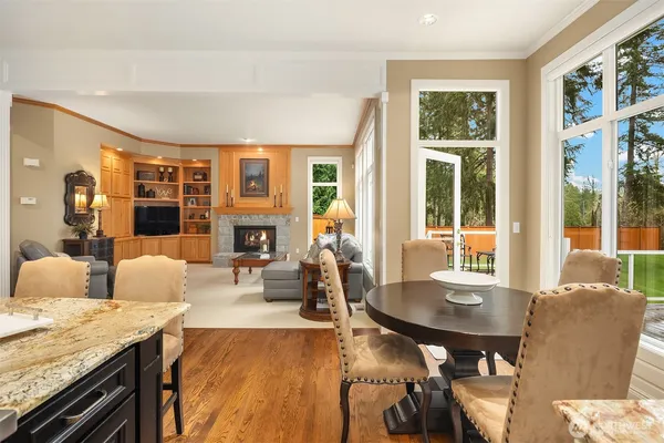a living room with fireplace furniture and a large window