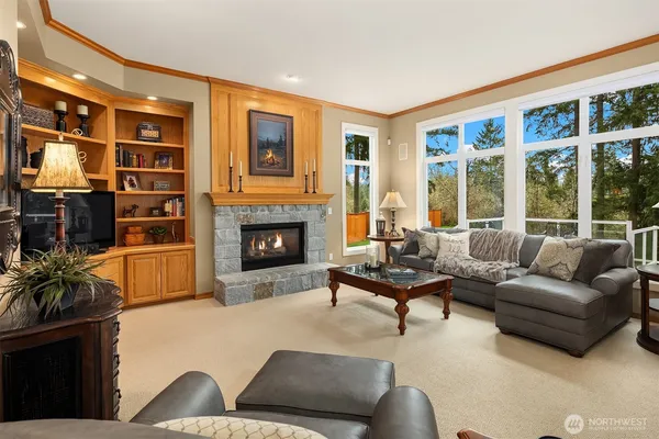a living room with furniture large window and fireplace