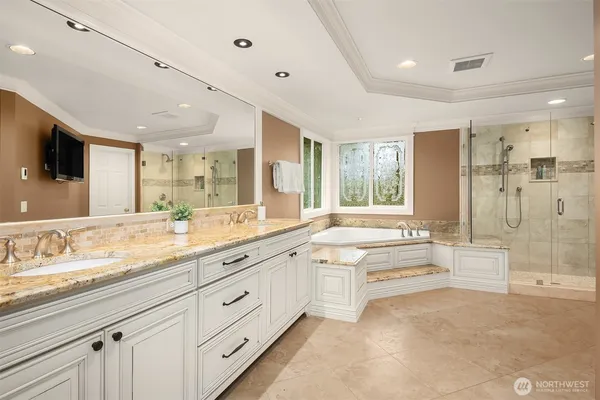 a large bathroom with a large mirror vanity and shower