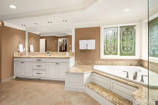 a bathroom with a bathtub sink and mirror