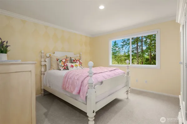 a spacious bedroom with a bed and a window