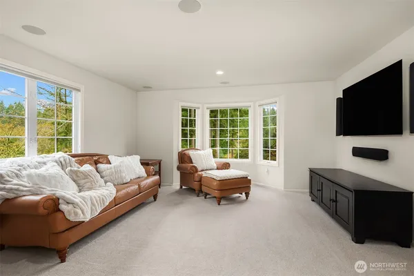 a living room with furniture window and flat screen tv