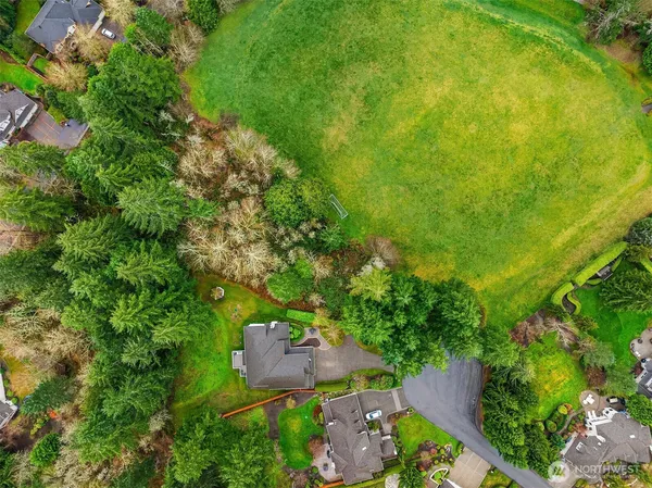 an aerial view of a house with a yard