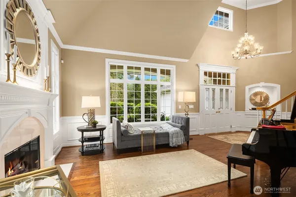a living room with furniture a fireplace and a chandelier