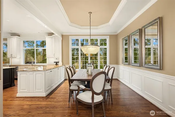 a view of a dining room with furniture windows and wooden floor