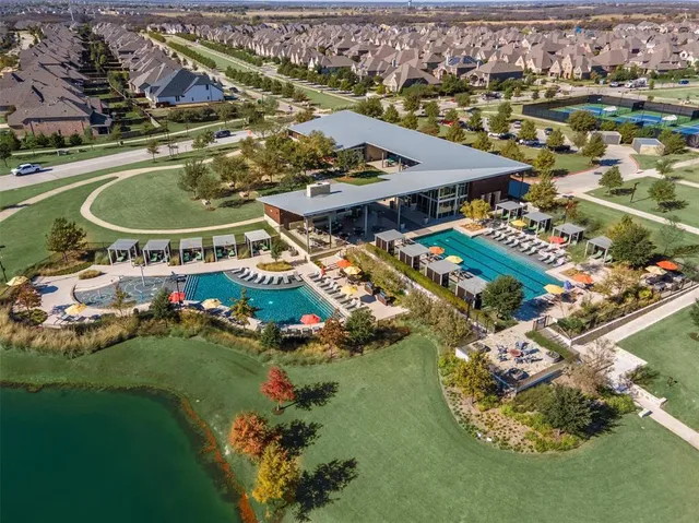 an aerial view of a house with yard swimming pool and outdoor seating