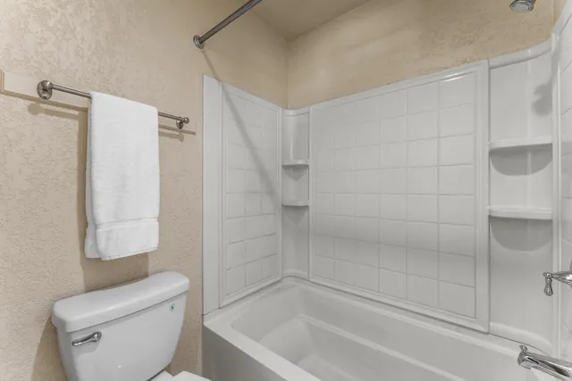 a bathroom with a toilet and shower