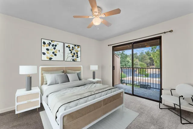 a bedroom with a large bed and a chandelier