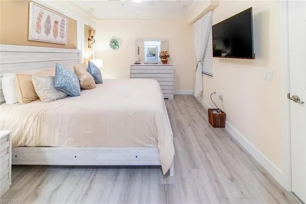 a bedroom with a bed and a flat screen tv