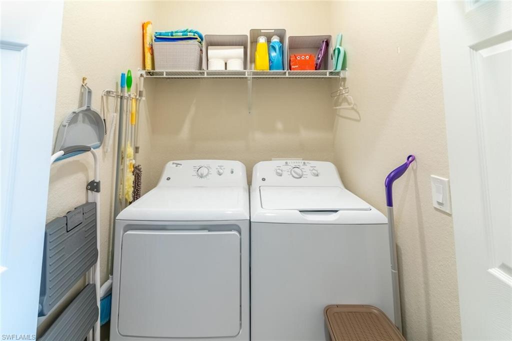 9596 Trevi Court, Unit 5446 Naples, FL 34113 - Photo 22 of 50 a utility room with dryer and washer
