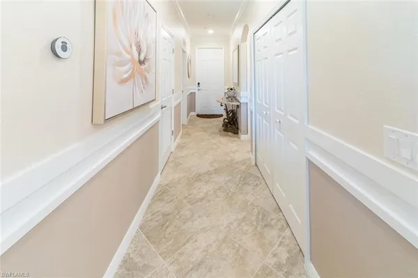 a view of a hallway with toilet and a hallway