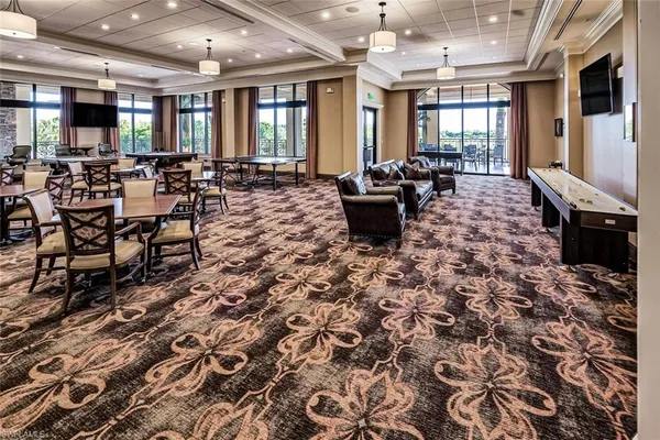 a living room with patio furniture and a floor to ceiling window