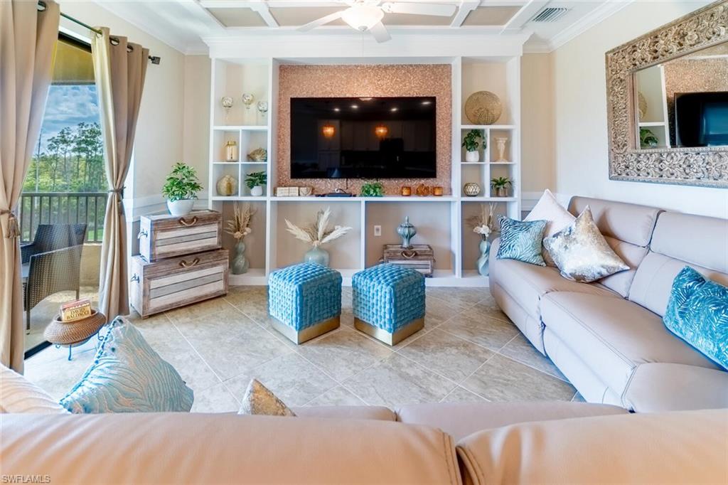 9596 Trevi Court, Unit 5446 Naples, FL 34113 - Photo 7 of 50 a living room with furniture and a flat screen tv