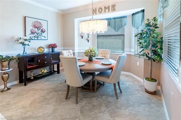 a dining room with furniture and a potted plant