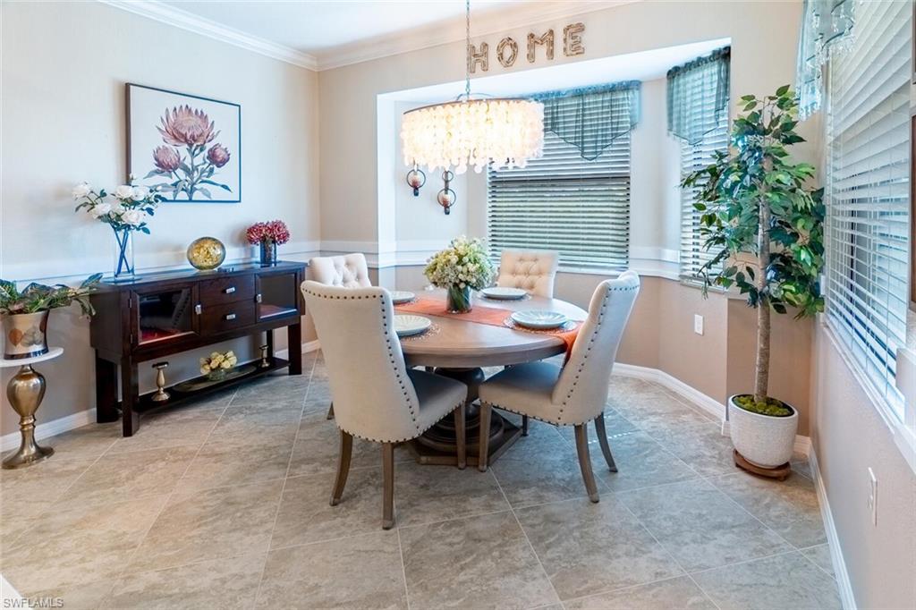 9596 Trevi Court, Unit 5446 Naples, FL 34113 - Photo 8 of 50 a dining room with furniture and a potted plant