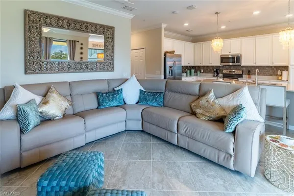 a living room with furniture and kitchen view