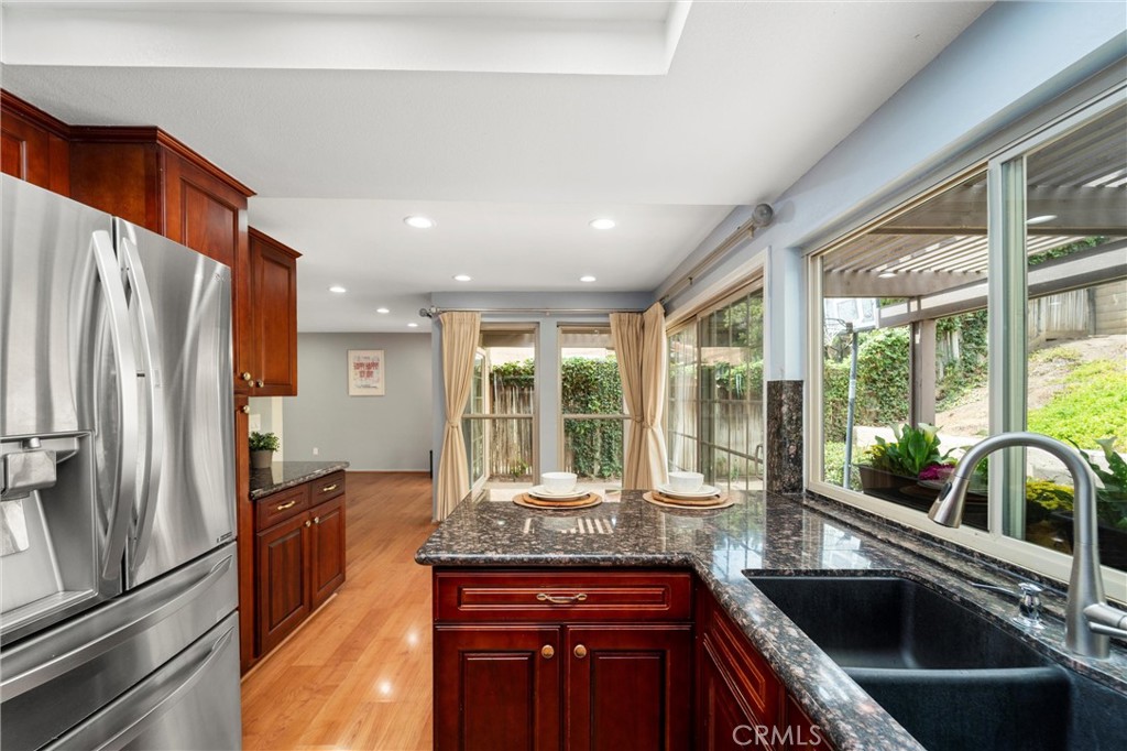 607 Valley Forge Drive Placentia, CA 92870 - Photo 14 of 57 a kitchen with granite countertop a sink and a refrigerator