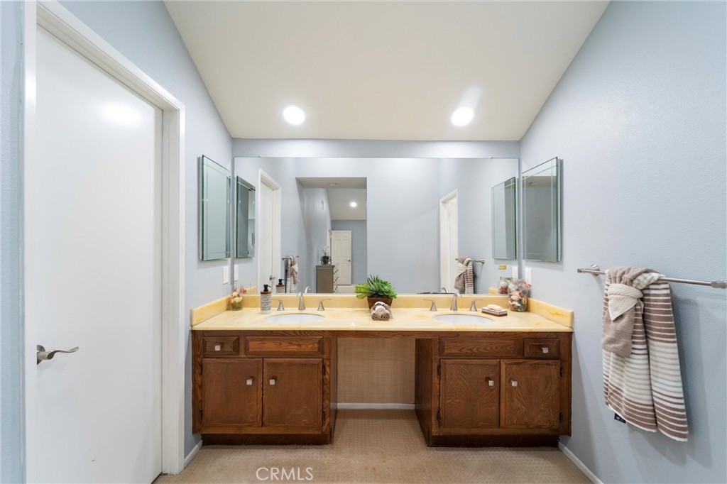607 Valley Forge Drive Placentia, CA 92870 - Photo 35 of 57 a bathroom with a double vanity sink and a mirror