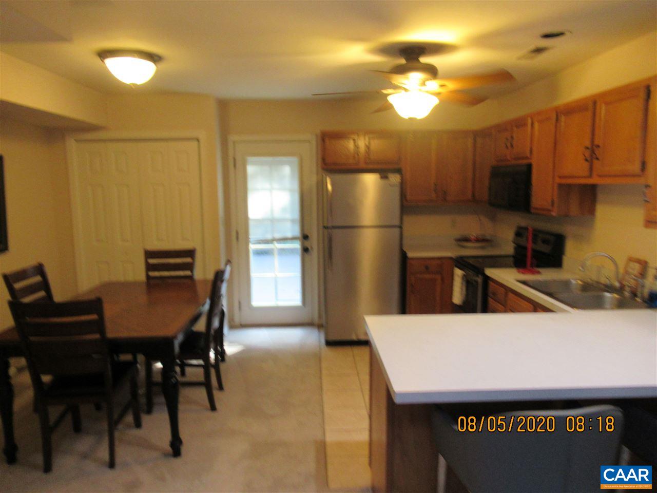 2 Ridgeview Circle Charlottesville, VA 22902 - Photo 7 of 22 a kitchen with stainless steel appliances a table chairs and refrigerator