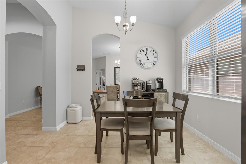 12154 Beach Fern Road Orlando, FL 32824 - Photo 12 of 34 a view of a dining room with furniture and a chandelier